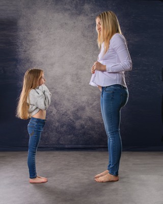  pregnant woman with small daughter in studio 