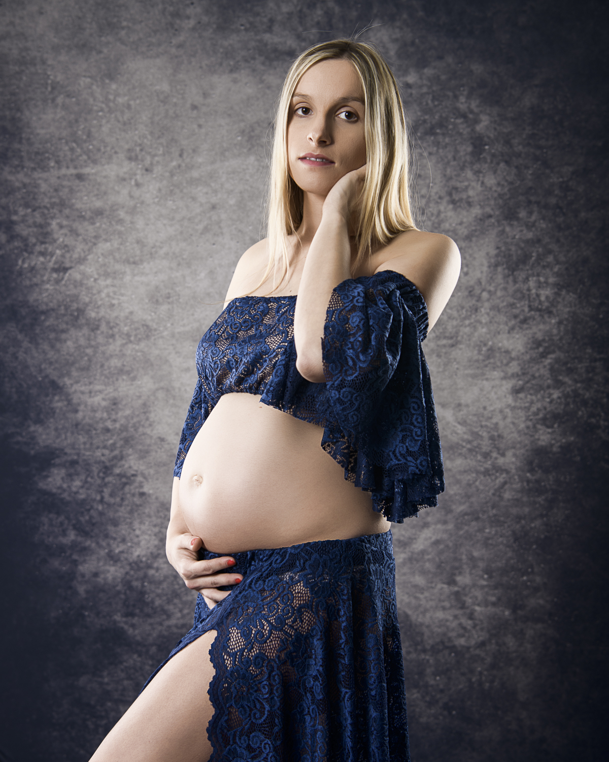 pregnant woman in studio on grey background