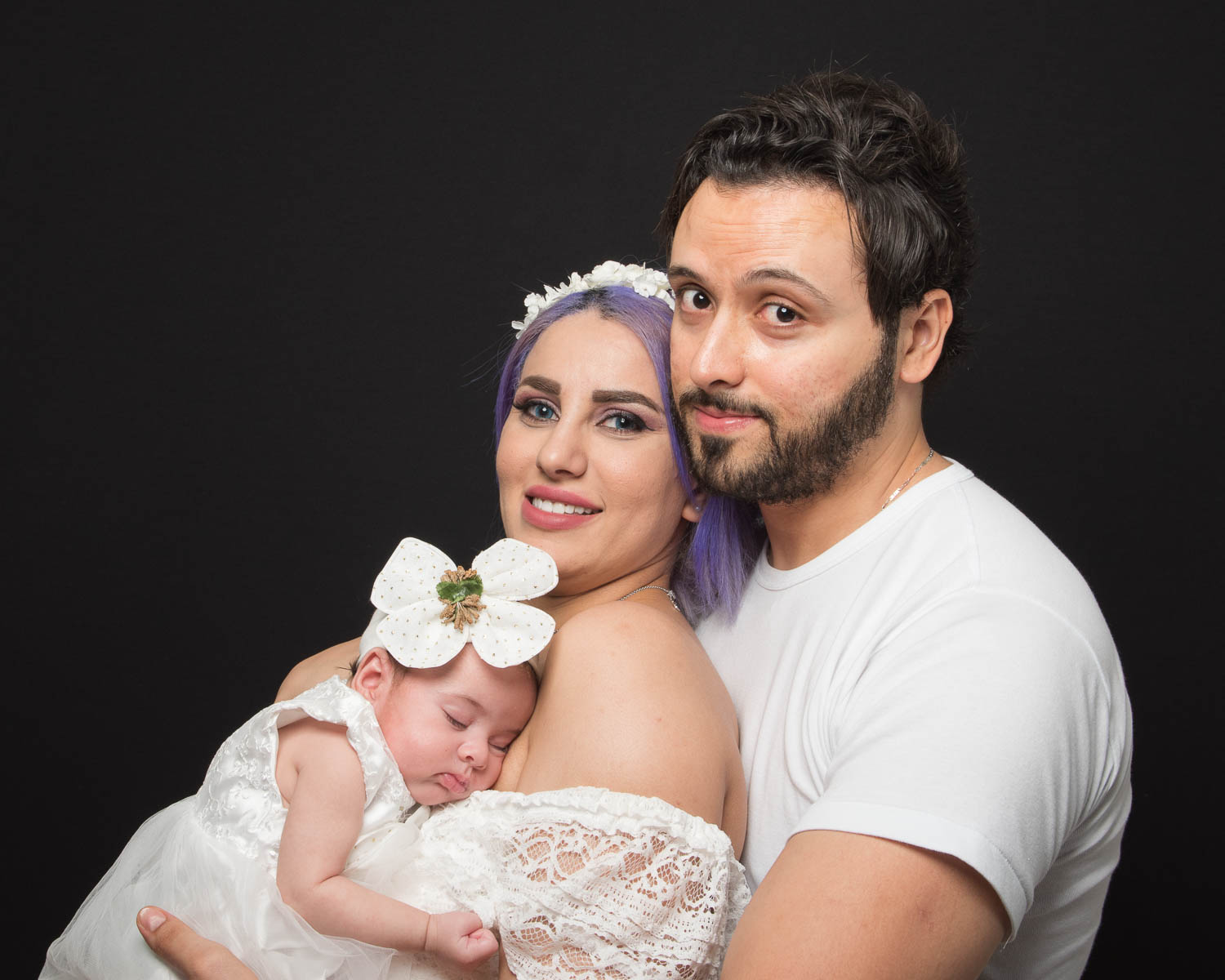  couple with newborn in studio 