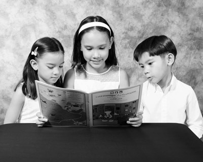 kid reading black and white portrait in studio 