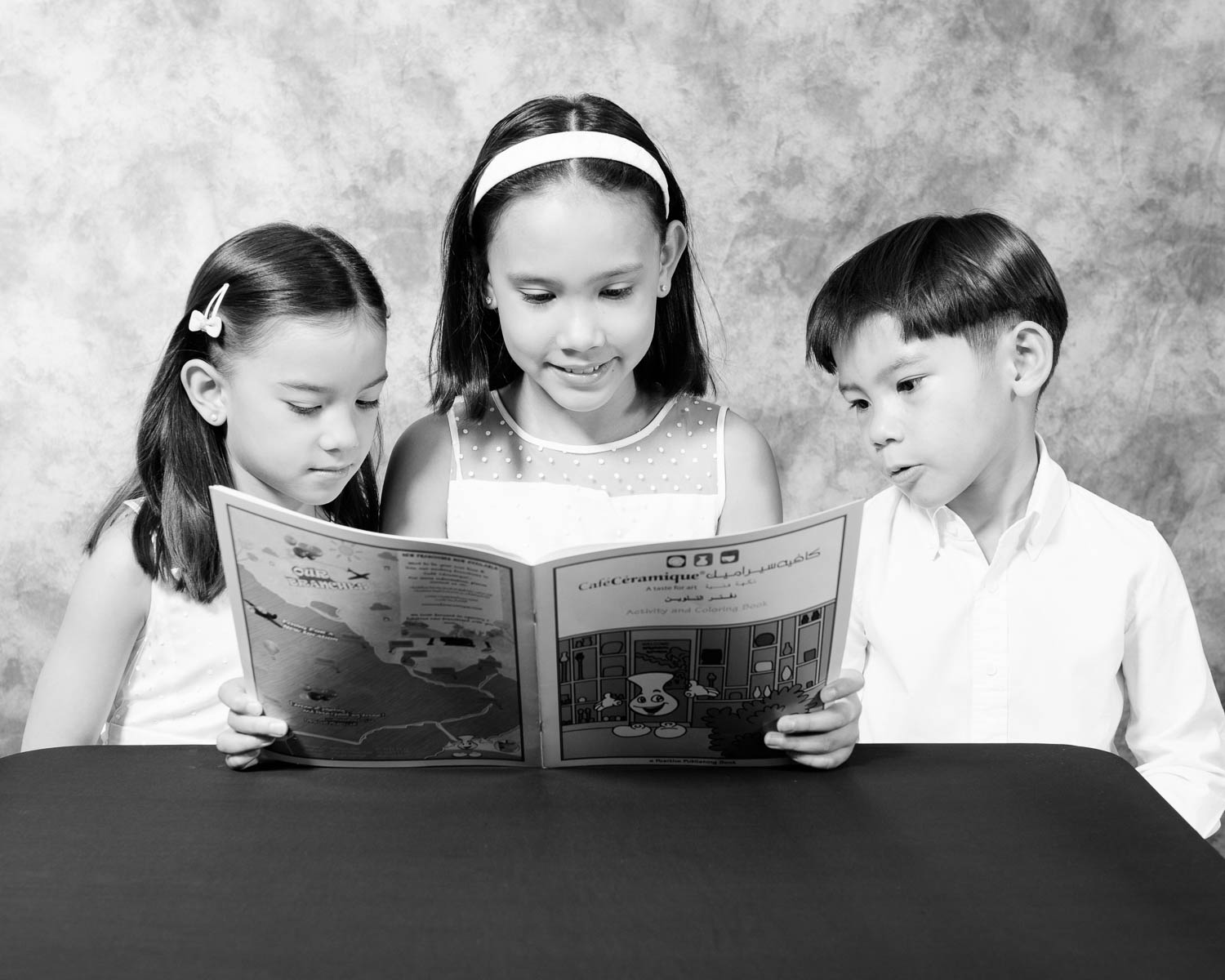  kid reading black and white portrait in studio 